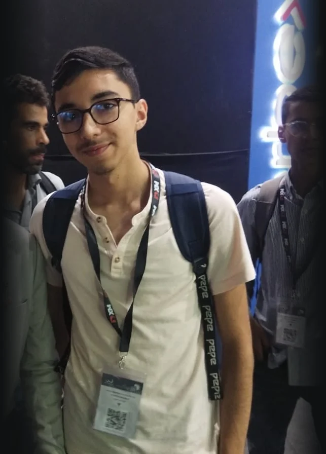Aymane with a lanyard and backpack at the African Fintech Summit in Casablanca
